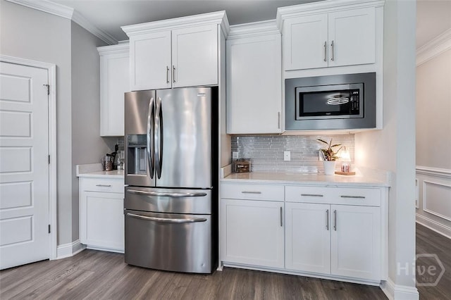 127 Champlain Dr, Pooler, GA 31322 - kitchen featuring stainless steel appliances, dark wood-style floors, crown molding, white cabinets, and decorative backsplash