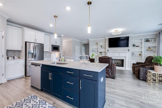 127 Champlain Dr, Pooler, GA 31322 - kitchen featuring stainless steel appliances, blue cabinetry, crown molding, white cabinets, and light countertops