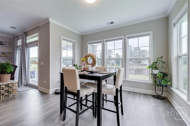 127 Champlain Dr, Pooler, GA 31322 - dining area with wood finished floors, healthy amount of natural light, and crown molding