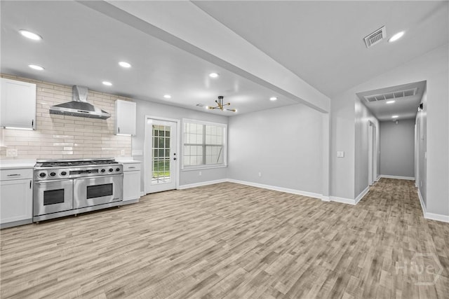 166 Old Sunbury Trl, Midway, GA 31320 - kitchen with wall chimney range hood, double oven range, light wood finished floors, light countertops, and recessed lighting