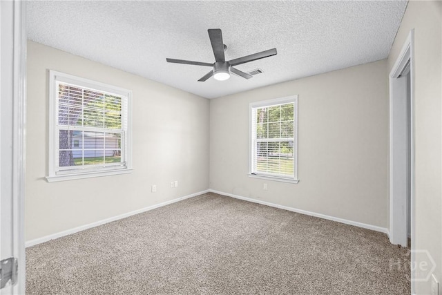 166 Old Sunbury Trl, Midway, GA 31320 - unfurnished bedroom with carpet flooring, a textured ceiling, a closet, and a ceiling fan