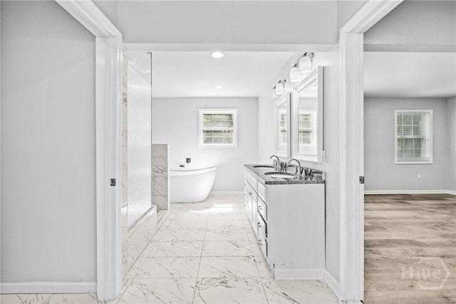 166 Old Sunbury Trl, Midway, GA 31320 - bathroom with marble look tile flooring, a soaking tub, vanity, and recessed lighting