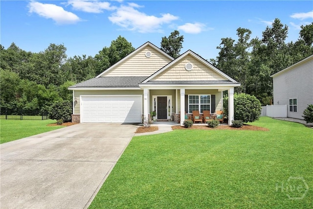 80 Sunbury Ct, Richmond Hill, GA 31324 - view of front of home featuring covered porch, concrete driveway, and an attached garage