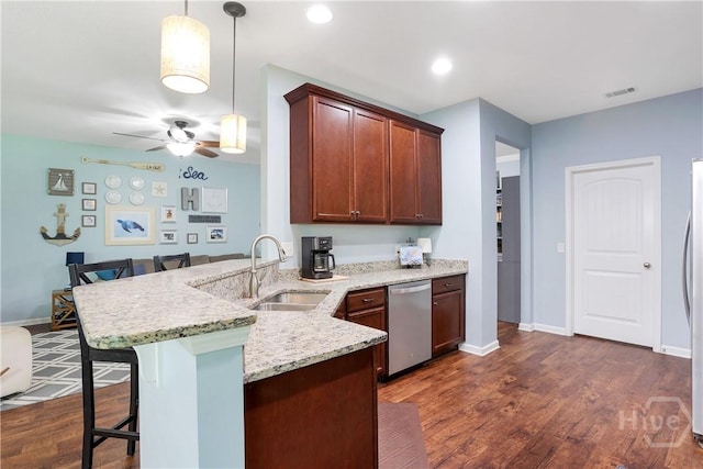 80 Sunbury Ct, Richmond Hill, GA 31324 - kitchen featuring dishwasher, a kitchen bar, a peninsula, dark wood-style flooring, and a ceiling fan