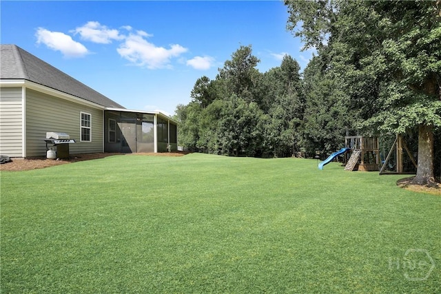80 Sunbury Ct, Richmond Hill, GA 31324 - view of grassy yard featuring a playground and a sunroom