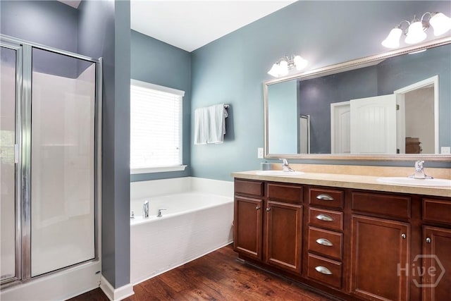 80 Sunbury Ct, Richmond Hill, GA 31324 - full bath featuring a shower stall, a bath, double vanity, and wood finished floors