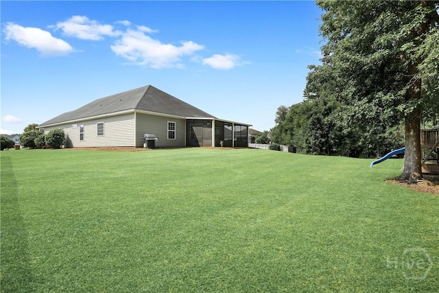 80 Sunbury Ct, Richmond Hill, GA 31324 - view of green lawn featuring a sunroom and a playground