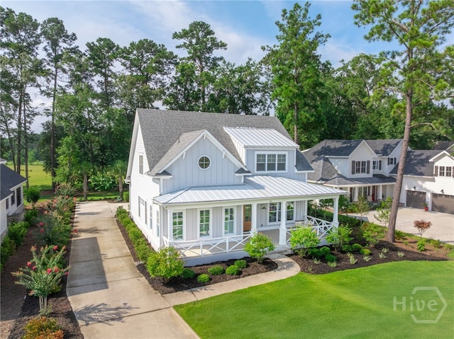 122 Kent, Pooler, GA 31322 - view of front facade with board and batten siding, driveway, a standing seam roof, covered porch, and a metal roof