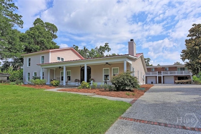 606 Rivers End Dr, Savannah, GA 31406 - view of front of property with ceiling fan, a front lawn, a chimney, asphalt driveway, and a porch