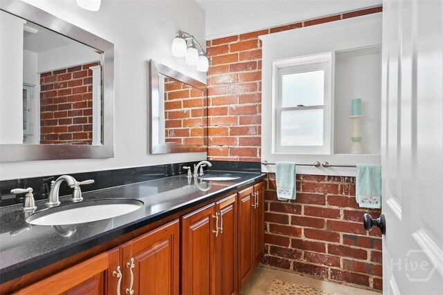 606 Rivers End Dr, Savannah, GA 31406 - bathroom featuring brick wall and double vanity