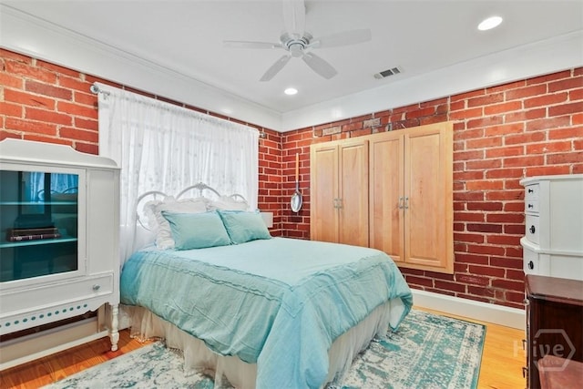 606 Rivers End Dr, Savannah, GA 31406 - bedroom with brick wall, wood finished floors, ceiling fan, and crown molding