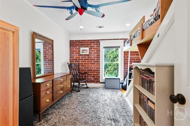 606 Rivers End Dr, Savannah, GA 31406 - sitting room with ceiling fan and brick wall