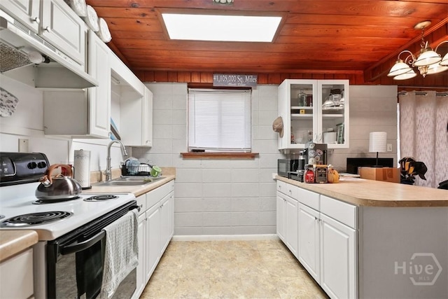 606 Rivers End Dr, Savannah, GA 31406 - kitchen with electric range, wooden ceiling, light countertops, under cabinet range hood, and white cabinets