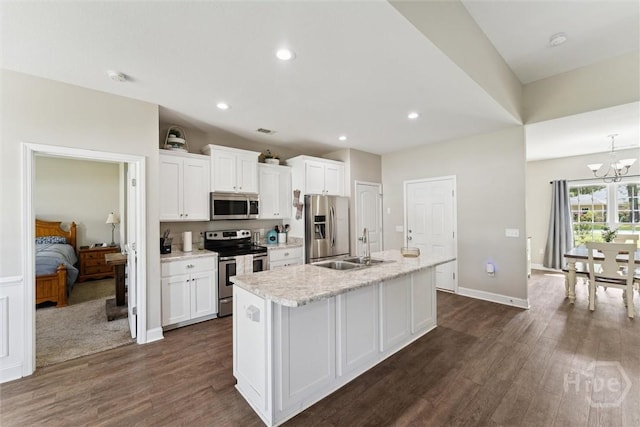 202 Orleans Trl, Statesboro, GA 30461 - kitchen featuring appliances with stainless steel finishes, an island with sink, white cabinetry, a chandelier, and dark wood-style flooring