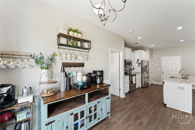 202 Orleans Trl, Statesboro, GA 30461 - kitchen featuring appliances with stainless steel finishes, white cabinetry, recessed lighting, dark wood-style flooring, and a chandelier