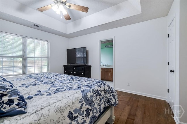 225 Jasper Ln, Rincon, GA 31326 - bedroom featuring dark wood finished floors, a tray ceiling, ceiling fan, and ensuite bath