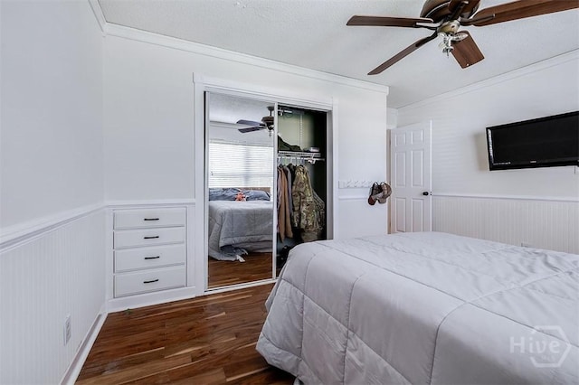 225 Jasper Ln, Rincon, GA 31326 - bedroom featuring a wainscoted wall, ornamental molding, dark wood-style flooring, a closet, and a ceiling fan