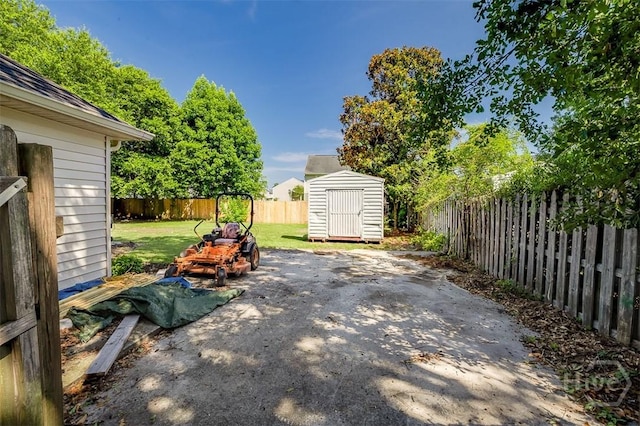 225 Jasper Ln, Rincon, GA 31326 - fenced backyard featuring a storage shed and a patio area