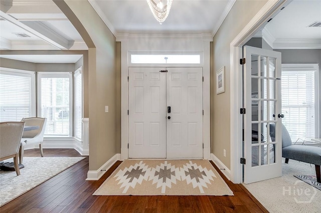 121 Cypress Loop, Bloomingdale, GA 31302 - entryway featuring dark wood-type flooring, healthy amount of natural light, arched walkways, and ornamental molding