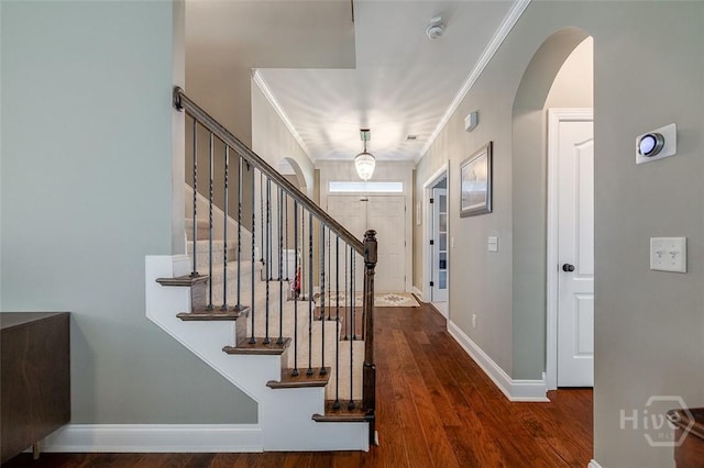 121 Cypress Loop, Bloomingdale, GA 31302 - entryway with wood finished floors, stairway, arched walkways, and crown molding