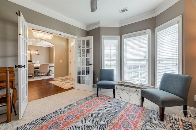 121 Cypress Loop, Bloomingdale, GA 31302 - living area with french doors, carpet flooring, arched walkways, healthy amount of natural light, and crown molding