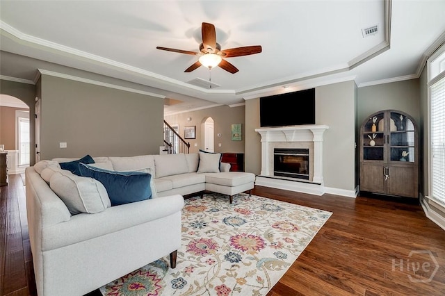 121 Cypress Loop, Bloomingdale, GA 31302 - living area featuring arched walkways, a tray ceiling, wood finished floors, and crown molding