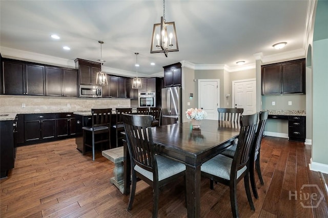 121 Cypress Loop, Bloomingdale, GA 31302 - dining space with dark wood-style flooring, a chandelier, ornamental molding, and recessed lighting