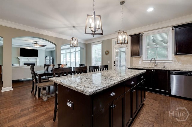121 Cypress Loop, Bloomingdale, GA 31302 - kitchen with stainless steel dishwasher, a breakfast bar, a ceiling fan, a fireplace, and a kitchen island