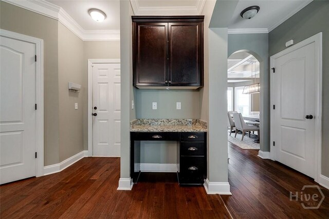 121 Cypress Loop, Bloomingdale, GA 31302 - bar area featuring dark wood-type flooring, ornamental molding, and arched walkways