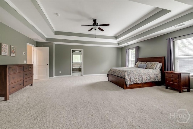 121 Cypress Loop, Bloomingdale, GA 31302 - bedroom featuring a tray ceiling, light colored carpet, multiple windows, and a ceiling fan