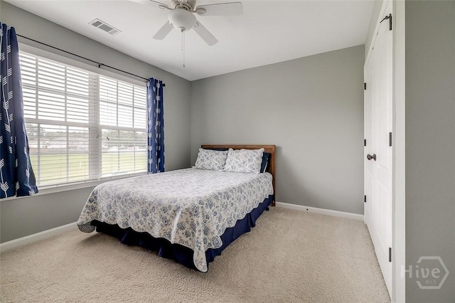 121 Cypress Loop, Bloomingdale, GA 31302 - bedroom with carpet floors, multiple windows, and a ceiling fan