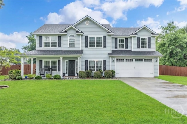 291 Kerry Dr, Richmond Hill, GA 31324 - traditional-style house featuring a garage, driveway, a porch, and a shingled roof