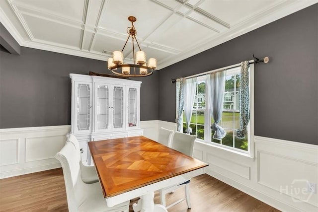 291 Kerry Dr, Richmond Hill, GA 31324 - dining room featuring a chandelier, coffered ceiling, a wainscoted wall, wood finished floors, and crown molding