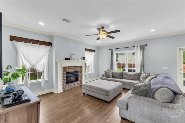 291 Kerry Dr, Richmond Hill, GA 31324 - living area with ceiling fan, wood finished floors, ornamental molding, a fireplace, and recessed lighting