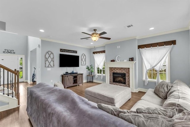 291 Kerry Dr, Richmond Hill, GA 31324 - living room with plenty of natural light, a ceiling fan, stairs, wood finished floors, and crown molding