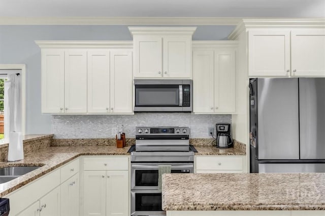 291 Kerry Dr, Richmond Hill, GA 31324 - kitchen featuring stainless steel appliances, light stone countertops, backsplash, and white cabinets