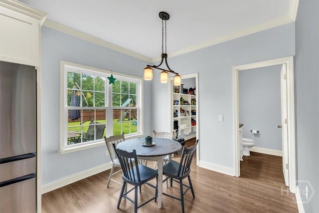 291 Kerry Dr, Richmond Hill, GA 31324 - dining room with wood finished floors and ornamental molding