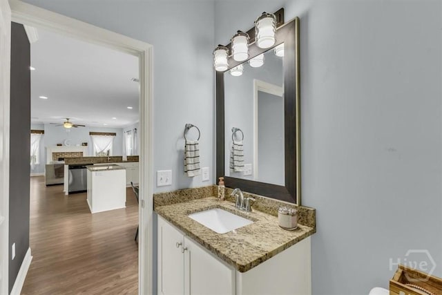 291 Kerry Dr, Richmond Hill, GA 31324 - bathroom with wood finished floors, vanity, ceiling fan, a fireplace, and recessed lighting