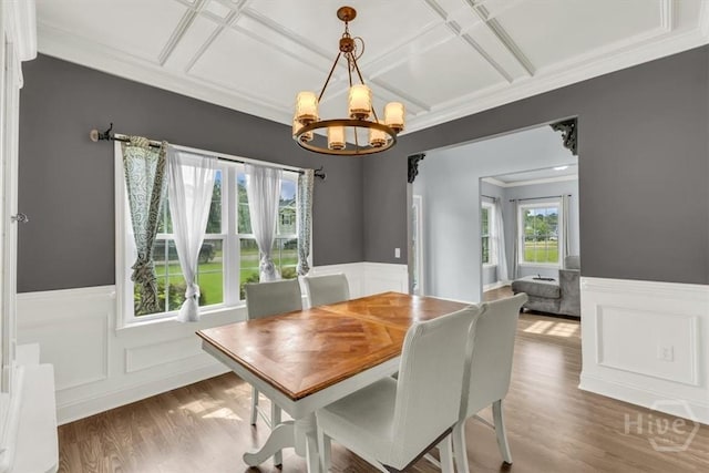 291 Kerry Dr, Richmond Hill, GA 31324 - dining room featuring a wainscoted wall, a chandelier, coffered ceiling, wood finished floors, and ornamental molding