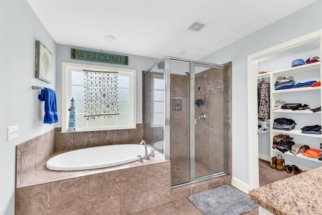 291 Kerry Dr, Richmond Hill, GA 31324 - full bath with a garden tub, a shower stall, a spacious closet, and vanity