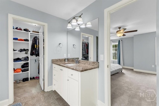 291 Kerry Dr, Richmond Hill, GA 31324 - full bathroom featuring vanity, a walk in closet, a ceiling fan, and ensuite bathroom