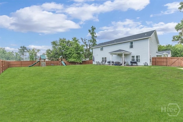 291 Kerry Dr, Richmond Hill, GA 31324 - rear view of house with a playground and a fenced backyard