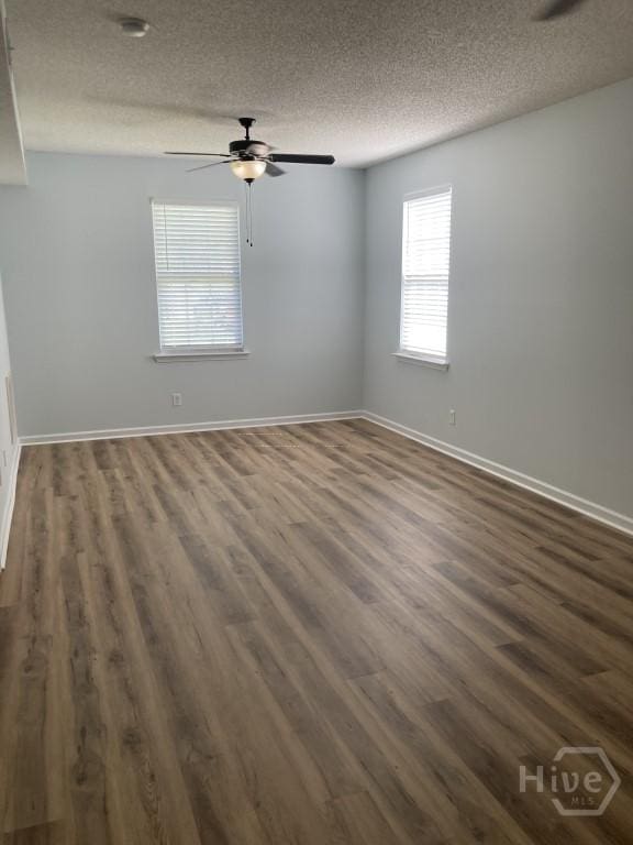 129 Ridgewood Cir, Rincon, GA 31326 - unfurnished room with a textured ceiling, dark wood-type flooring, and a ceiling fan