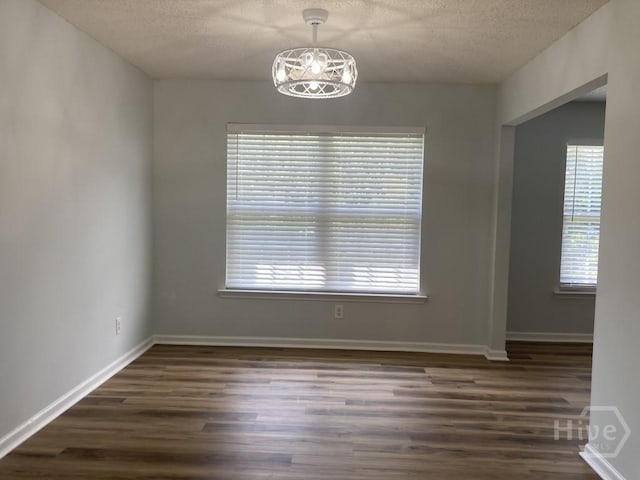 129 Ridgewood Cir, Rincon, GA 31326 - spare room with dark wood-type flooring and a textured ceiling
