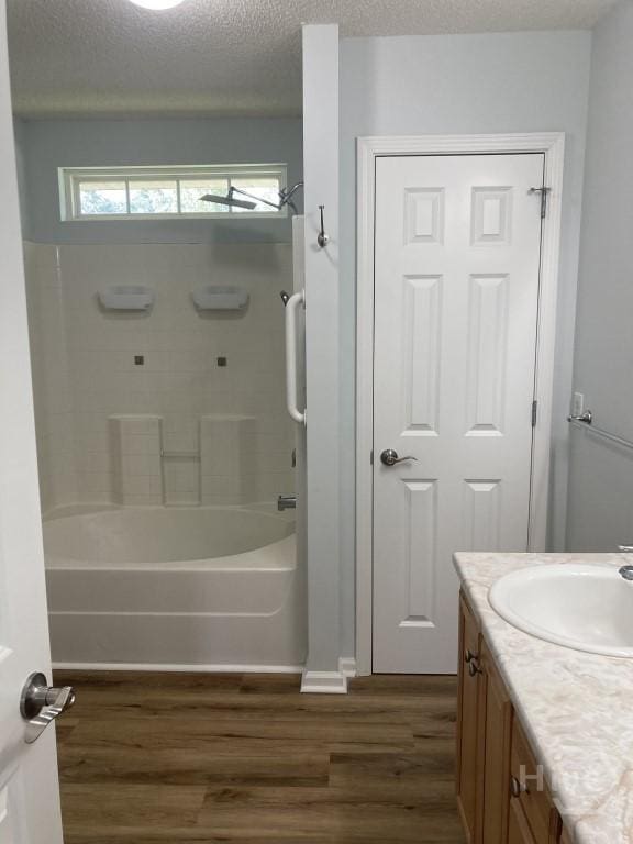 129 Ridgewood Cir, Rincon, GA 31326 - bathroom featuring wood finished floors, vanity, bathtub / shower combination, and a textured ceiling