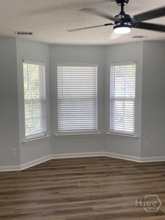 129 Ridgewood Cir, Rincon, GA 31326 - empty room with dark wood-type flooring, a textured ceiling, and ceiling fan