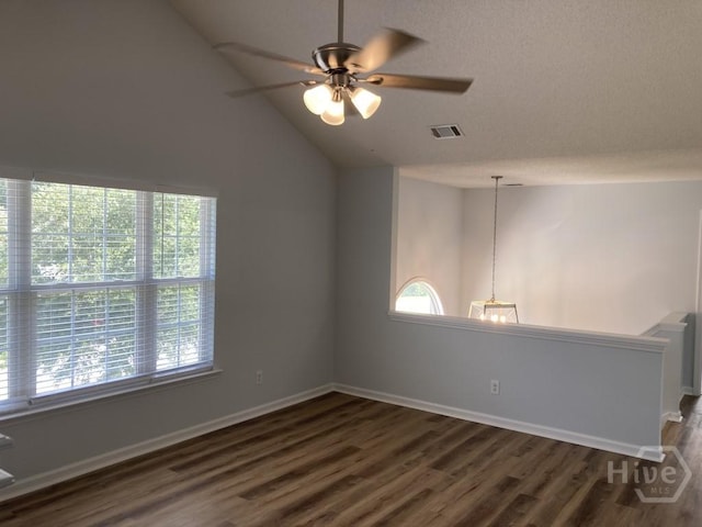 129 Ridgewood Cir, Rincon, GA 31326 - spare room with dark wood-style flooring, lofted ceiling, and ceiling fan