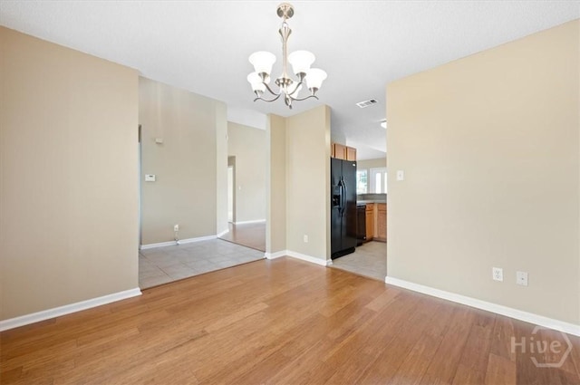 10 Cassidy Ct, Pooler, GA 31322 - empty room with light wood-type flooring and a chandelier