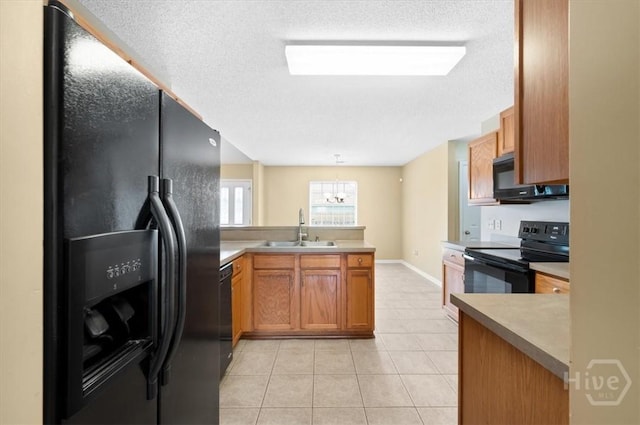 10 Cassidy Ct, Pooler, GA 31322 - kitchen featuring black appliances, a peninsula, a textured ceiling, a chandelier, and light tile patterned floors