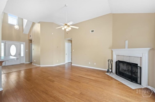 10 Cassidy Ct, Pooler, GA 31322 - unfurnished living room featuring high vaulted ceiling, light wood-style flooring, a tile fireplace, and a ceiling fan